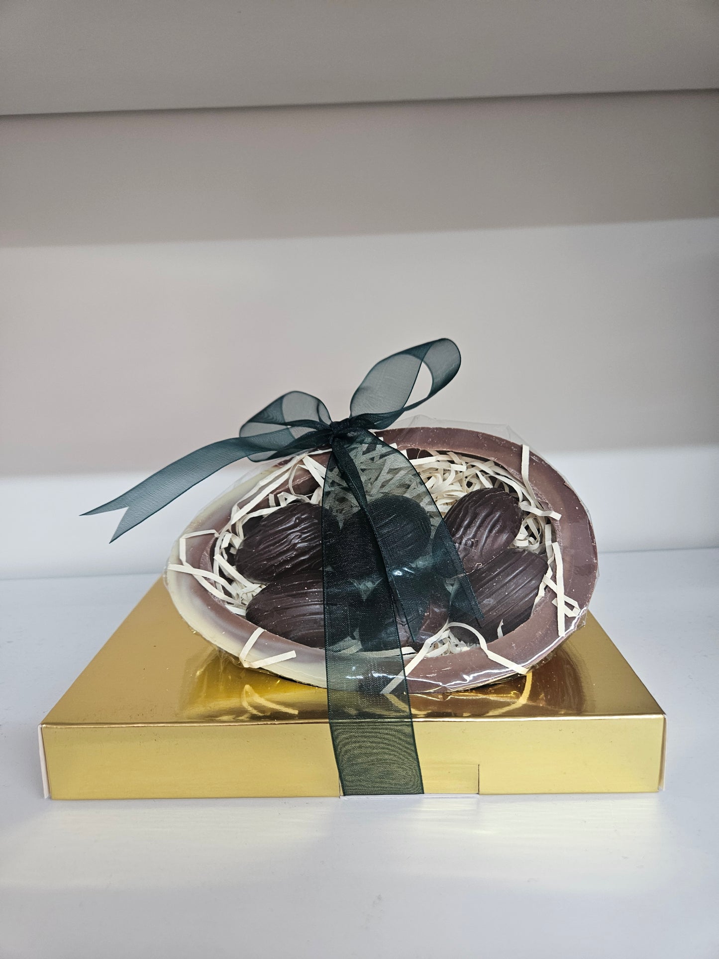 Marbled Milk & White Chocolate half egg filled with Dark chocolate mint crisp half shell eggs.