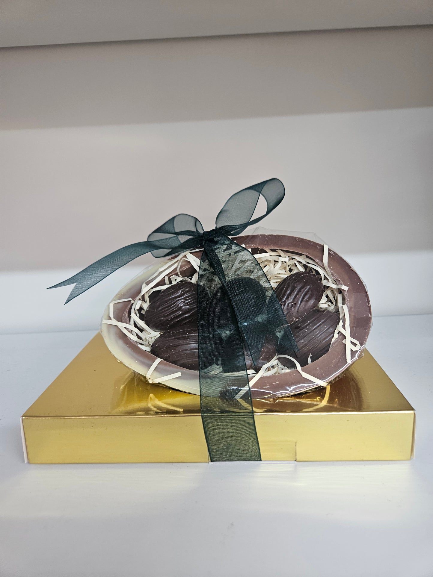 Marbled Milk & White Chocolate half egg filled with Dark chocolate mint crisp half shell eggs.
