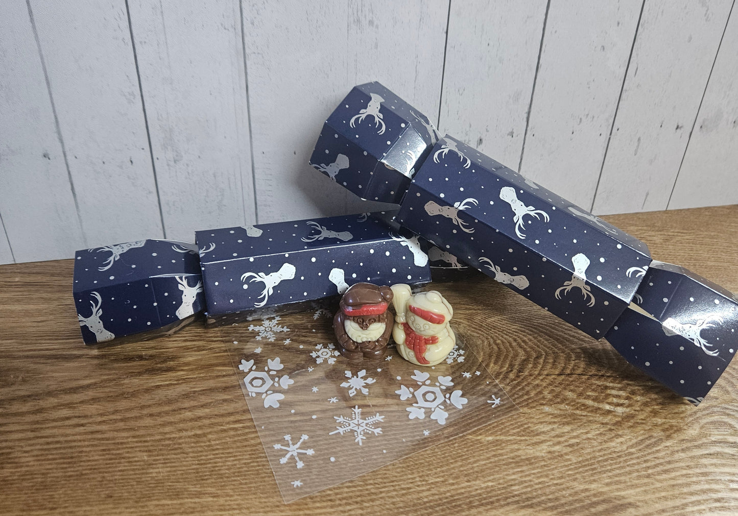 Christmas crackers filled with milk chocolate hazelnut praline santa & white chocolate hazelnut praline snowman